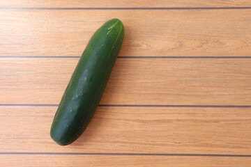Cucumber on wooden background, with copy space. Organic food.