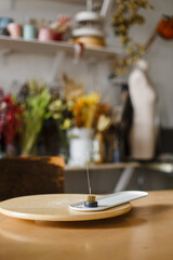 Aroma stick on the background of a beautiful florist's trowel