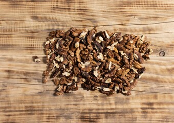 Walnut kernel on wooden brown background