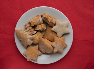 Figured homemade cookies on a wooden background in a plate.