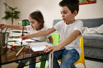 Two creatively adorable children, draw at home. Art lesson at home, Easter theme, watercolor technique. Art education