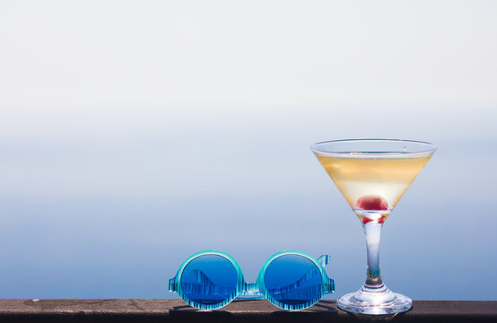 glass of martini over the sea background