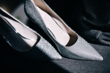 Close-up photo of the bride's shoes. Amazing gray shining shoes.