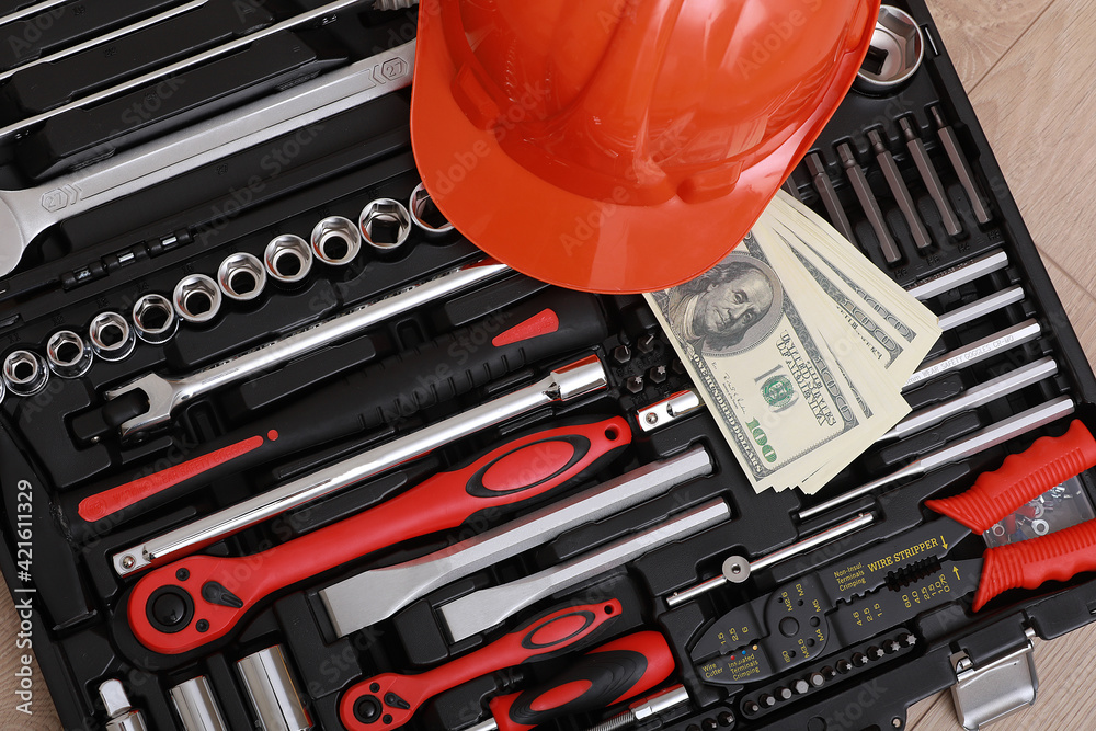 Wall mural toolbox, tools kit detail, dollar bills and orange protective helmet close up. instruments. set of t