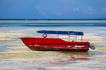 Tourist boat at low tide on Paje beach