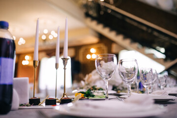 beautifully laid tables with glasses and appliances at morning in restaurant.