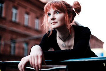 Fototapeta na wymiar girl with red hair in black clothes portrait