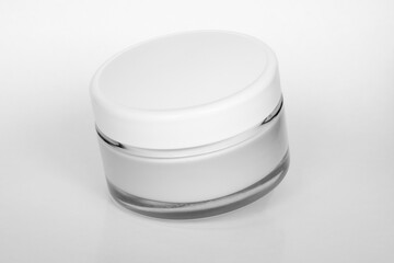 Moisturizing cream jar on white background. Moisturizer packaging mockup. Skin care, beauty product concept.