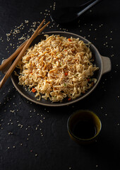 Obraz na płótnie Canvas Sesame seed teriyaki dish with black sauce on black background