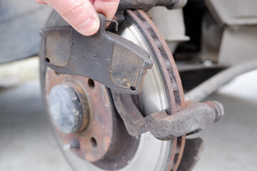 Car repair. Replacing the brake pads of disc brakes. Brake disc close-up.