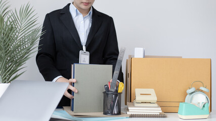 Put the work equipment in the office in a large brown box, Businessmen are keeping work documents...