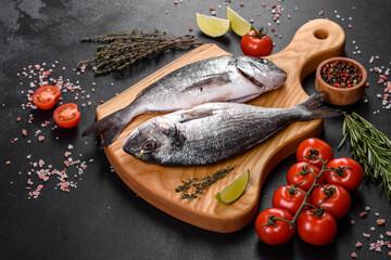 Raw dorado fish with spices cooking on cutting board. Fresh fish dorado