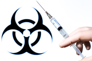 Syringe filled with liquid on white background with biohazard symbol