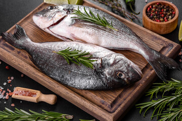 Raw dorado fish with spices cooking on cutting board. Fresh fish dorado