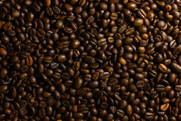 Coffee beans. Coffee beans are spread out on the surface.
