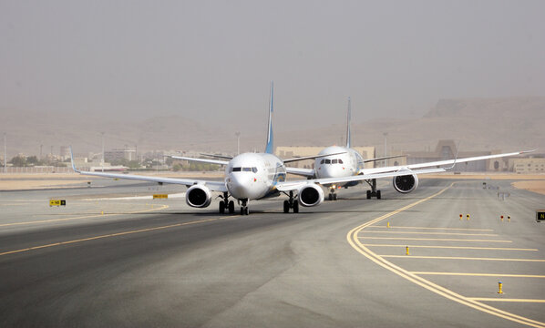 Muscat, Oman, picture dated 18 July 2019 Muscat new airport with Oman air planes. Aircraft on the runway are preparing for departure.
