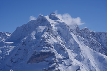 Fototapeta na wymiar Mountain peak Jungfrau (virgin) seen from Mürren, Lauterbrunnen, Switzerland.