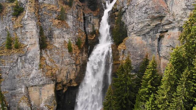 Drone flying over a green forest around a big waterfall in the mountains. Aerial Drone footage 4K. Beautiful nature landscape scene showing the famous waterfall in the Carpathian Mountains, Vanturis