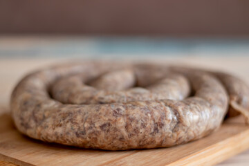 The texture of a raw homemade pork sausage, photographed with a selective focus with a blurred background