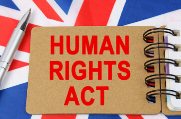 Against the background of the flag of Great Britain lies a notebook with the inscription - HUMAN...