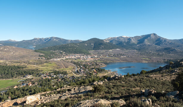 View of the lake and the village of Navacerrada Madrid with the Sierra de Guadarrama in the background - Siete Picos - Bola del Mundo - La Maliciosa