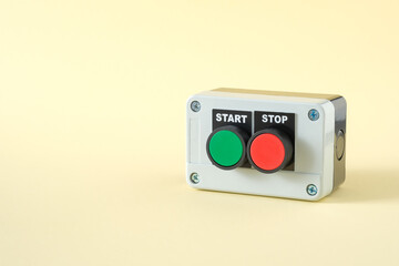 Push button station with green start and red stop buttons on pastel background