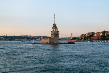 Fototapeta premium Maiden Tower, Kiz Kulesi on the Asian side of Istanbul at sunset in the middle of Bosphorus, Turkey. One of the symbols of Istanbul. Ancient lighthouse of the Ottoman period. Girl tower. 