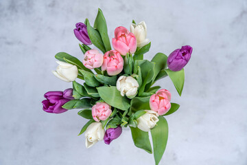 A bouquet of tulips from above on a gray background. Happy holiday concept ER