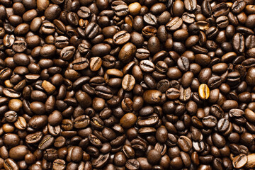 Coffee beans. Coffee beans are spread out on the surface.