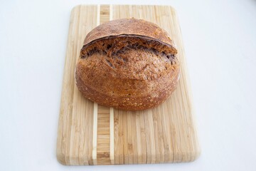 loaf of rye bread on wood board