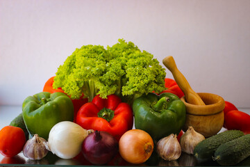 Prepare for a wonderful vegetarian lunch. Washed bell peppers, onions, garlic and lettuce leaves