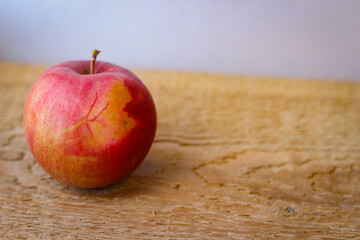 Red apple stand on a wooden surface