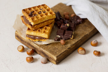 Waffles with chocolate spread, chocolate with hazelnuts. Background image, sweet snack