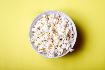 Home made popcorn on a yellow background