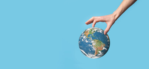 3D Earth planet globe in man, woman hand, hands on blue background. Environmental protection concept. Elements of this image furnished by NASA
