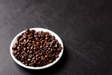 Cup of coffee with beans on table, top view