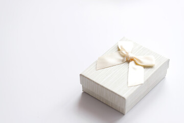 Craft gift box on a white background, decorated with a bow. For birthday, anniversary presents, gift post cards.