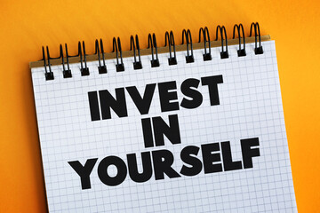 Invest In Yourself text on notepad, concept background