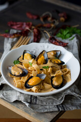 pasta with mussels on a white plate