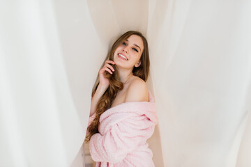 Happy rich young woman wear night robe in modern home hotel, good morning lifestyle concept