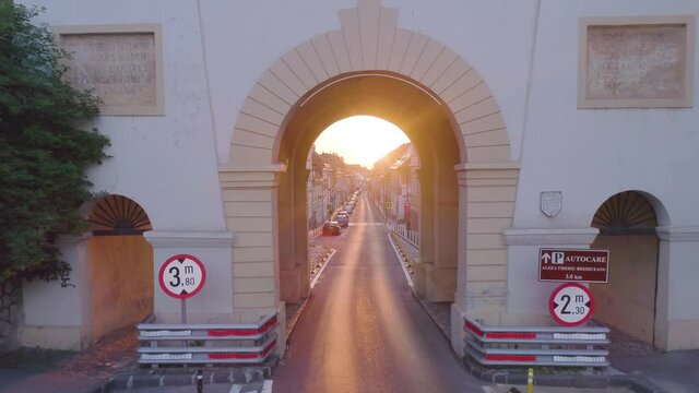 Şchei Gate in Braşov, Romania. Streets of Brasov city. Old medieval city in Europe. Touristic destination. City scape. Travel on empty street. Beautiful morning sunrise