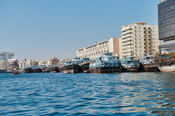 Dubai creek and water traffic there: cargo ships, touristic boats and docked ships