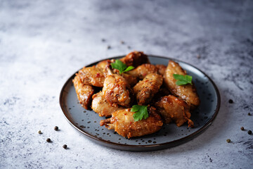 Spicy baked wings in a plate