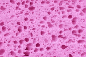 Texture of a pink sponge made of foamed polyurethane as a background