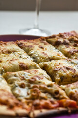 Delicious homemade hot Italian pizza ready to eat. With tomato, ham, mozzarella cheese and four cheeses.