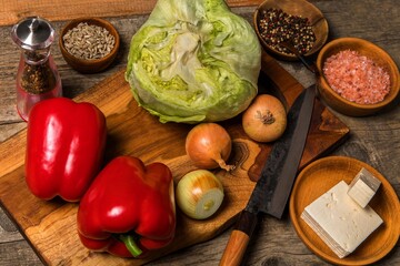 Homemade salad preparation with Iceberg lettuce and tomatoes. Ingredients for vegetable salad. Diet food.