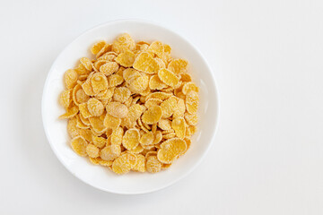 Corn flake in a bowl on white background. Healthy breakfast concept.
