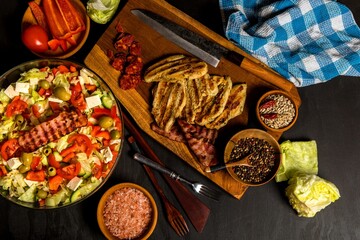 Vegetable salad with chicken and bacon. Salad with tomatoes and cheese. Diet food. Chicken steak with vegetables.