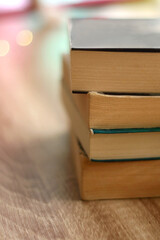 Stack of books on wooden table. Selective focus.