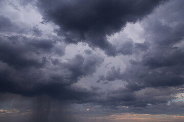 Obraz premium Epic Dramatic Storm sky with dark grey cumulus rainy clouds with rain background texture, thunderstorm, heavy rain